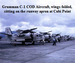 Grumman C-1 COD Aircraft, wings folded, 
sitting on the runway apron at Cubi Point
