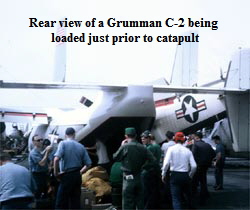Rear view of a Grumman C-2 being 
loaded just prior to catapult